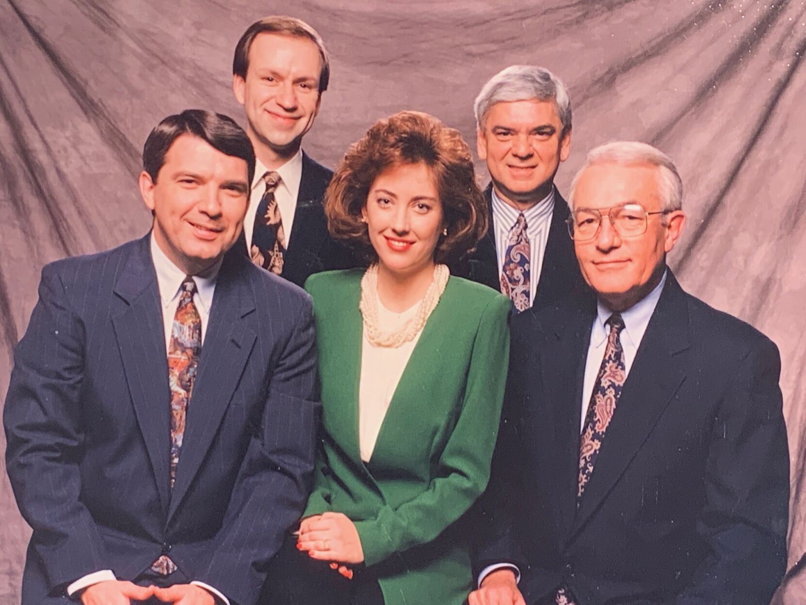 Larry McIntosh, seen in the right rear of this photo, poses with fellow members of the Local 6 news team in the mid-1980s.
